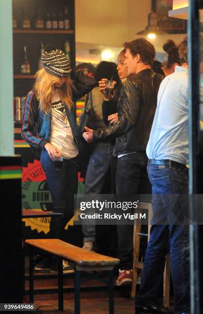 Model Cara Delevingne enjoys a night out with friends at Boom Burger, in Notting Hill on June 3, 2014 in London, England.