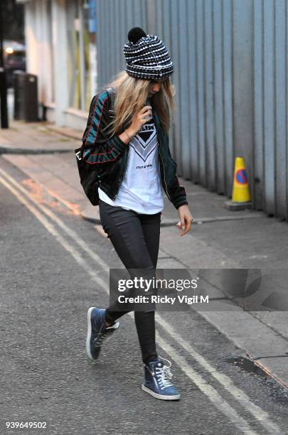 Model Cara Delevingne enjoys a night out with friends at Boom Burger, in Notting Hill on June 3, 2014 in London, England.