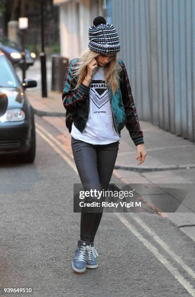 Model Cara Delevingne enjoys a night out with friends at Boom Burger, in Notting Hill on June 3, 2014 in London, England.