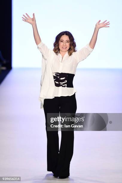 Designer Cigdem Akin acknowledges the applause of the audience after her show during Mercedes Benz Fashion Week Istanbul at Zorlu Performance Hall on...