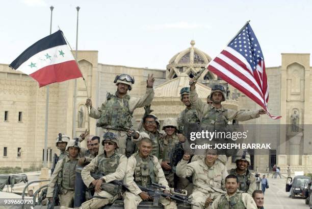 Marines wave US and Iraqi flags 14 April 2003 in front of al-Faruq Palace in the city of Tikrit, toppled iraqi President Saddam Hussein's hometown,...