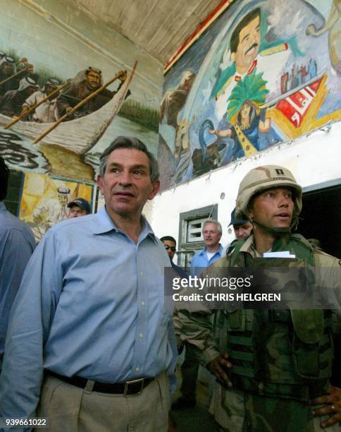 Deputy Secretary of Defense Paul Wolfowitz scans murals of toppled Iraqi leader Saddam Hussein while touring Iraq's Abu Gharib prison on the...