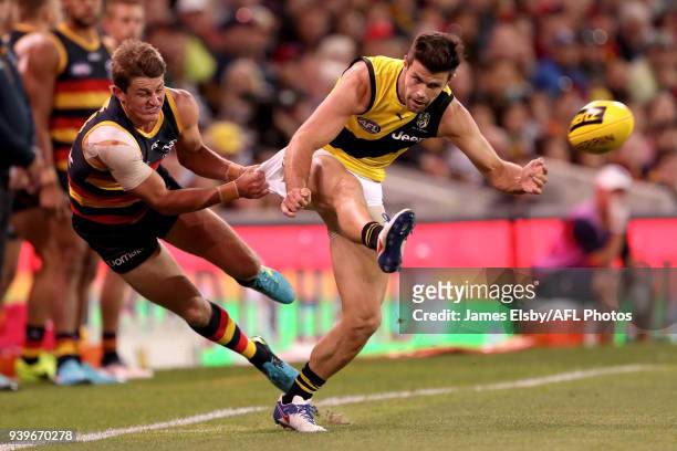 Matt Crouch of the Crows tackles Trent Cotchin of the Tigers during the 2018 AFL round 02 match between the Adelaide Crows and the Richmond Tigers at...