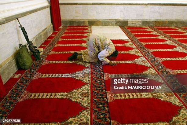 Army sergeant Mesahchai Whitaker from the 4th Infantry Division , performs the Friday noon prayers in al-Hara al-Gabir mosque at the palace compound...