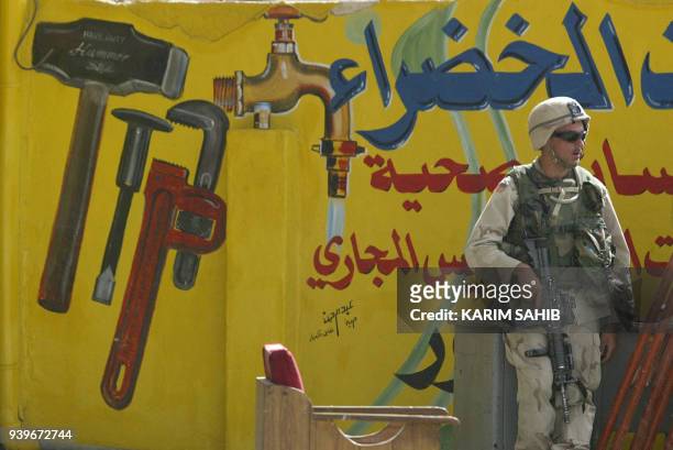 Soldier patrols a street in Baghdad 28 October 2003, one day after a series of bloody attacks around the Iraqi capital. Five suicide bombings in the...
