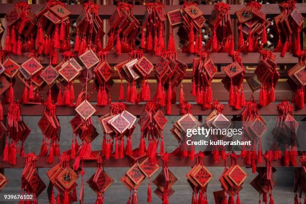 small tiles with writings on it seeking blessings hanging by board, at beihai park temple, beijing - beihai stock pictures, royalty-free photos & images