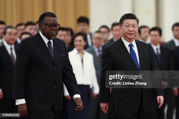 Chinese President Xi Jinping invites Namibia's President Hage G. Geingob to view an honour guard during a welcoming ceremony inside the Great Hall of...