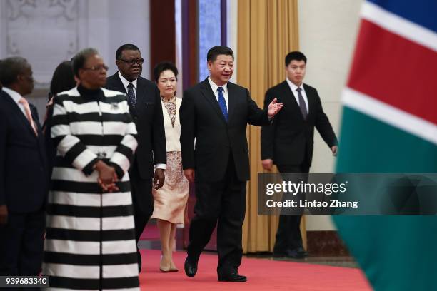 Chinese President Xi Jinping invites Namibia's President Hage G. Geingob to view an honour guard during a welcoming ceremony inside the Great Hall of...