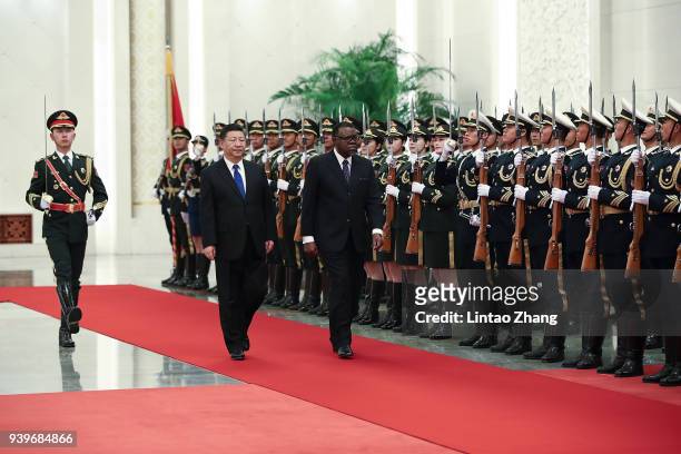 Chinese President Xi Jinping accompanies Namibia's President Hage G. Geingob to view an honour guard during a welcoming ceremony inside the Great...