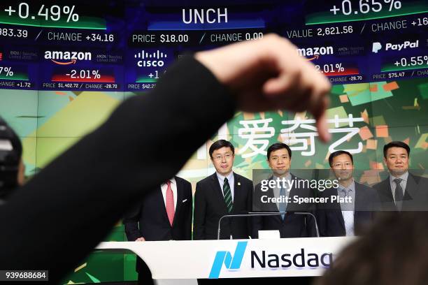 Yu Gong , Founder and CEO of China-based iQiyi , rings the Opening Bell at Nasdaq MarketSite in Times Square with employees and investors in...