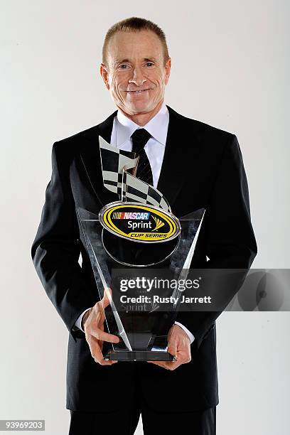 Driver Mark Martin poses with the 2nd place award during the NASCAR Sprint Cup Series awards banquet during the final day of the NASCAR Sprint Cup...