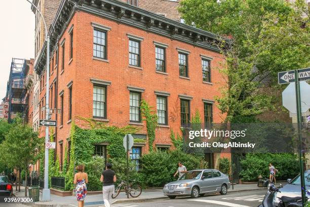 residential apartment building at the corner of greenwich and w 11 street in west village, manhattan west side, new york city. - west village stock pictures, royalty-free photos & images