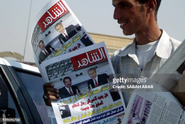 Street vendor hawks copies of Al-Shahed newspaper 25 September 2003 in Baghdad headlining the speculation that reads: "The Disappearance of Saddam: A...