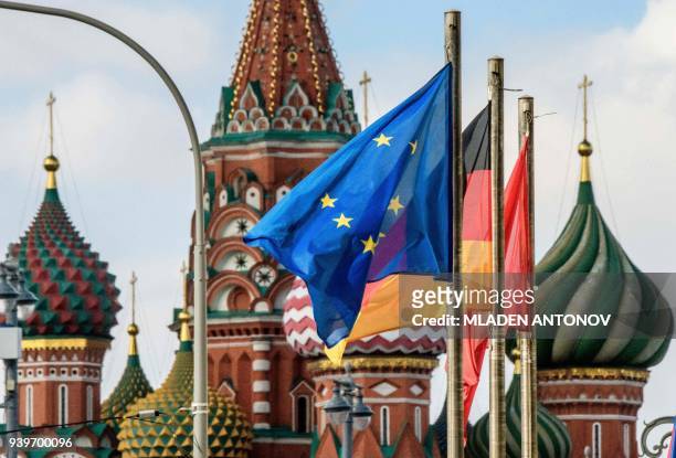 The European Union flag flies among others in front of St.Basil's Cathedral in Moscow on March 29, 2018. At least 25 countries have ordered out more...