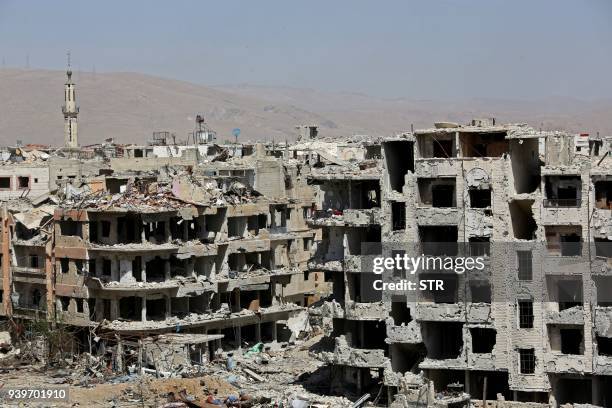 This picture taken on March 29 shows destroyed buildings in Harasta nearly a week after the regime forces retook the town from the rebels, in Eastern...