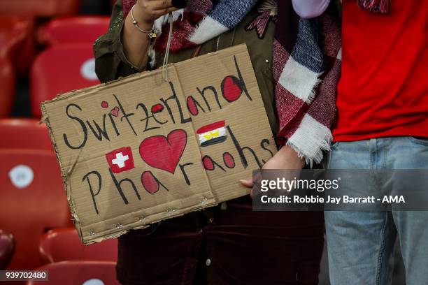 Fans of Egypt and Switzerland hold up a banner which reads Switzerland Pharaohs during the International Friendly match between Egypt and Greece at...