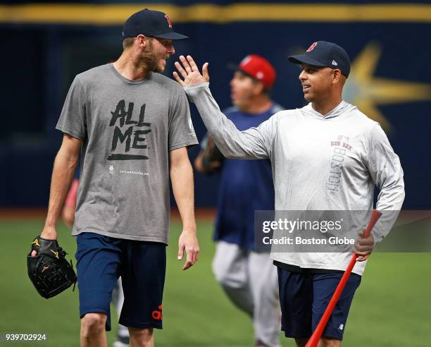 Boston Red Sox Opening Day starting pitcher Chris Sale, laughs as he walks off the field with Red Sox manager Alex Cora at the conclusion of the...