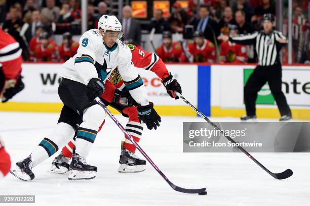 San Jose Sharks left wing Evander Kane battles with Chicago Blackhawks defenseman Connor Murphy in action during a game between the Chicago...