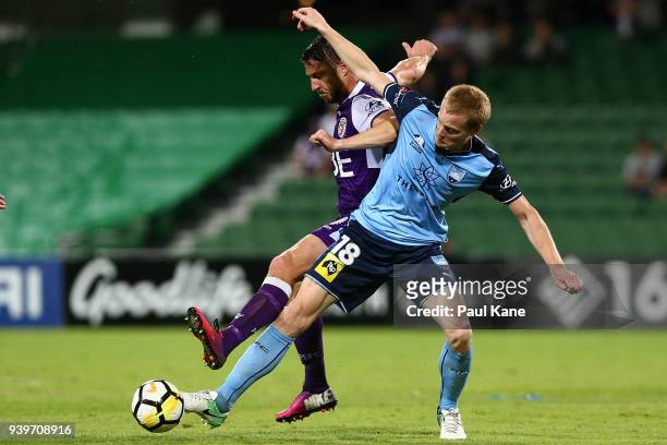 Dino Djulbic of the Glory and Matt Simon of Sydney contest for the ball during the round 25 A-League match between the Perth Glory and Sydney FC at...