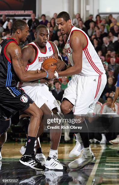 Dante Milligan of the Springfield Armor battles with Noel Felix and Alexis Ajinca of the Maine Red Claws during the game on December 4, 2009 at the...
