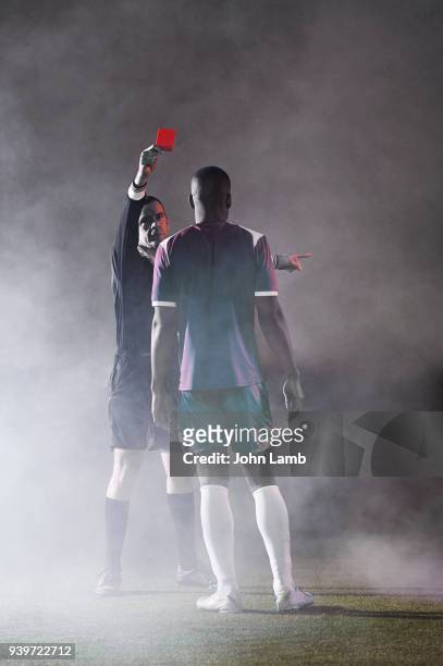 referee showing footballer red card. - referee card stock pictures, royalty-free photos & images