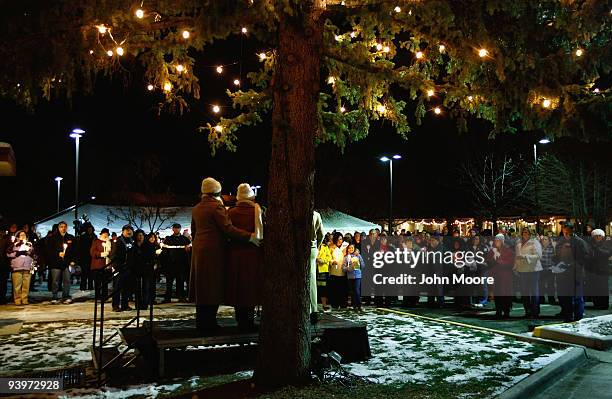 Hundreds of family members sing "Silent Night" at a Christmas tree lighting ceremony to honor loved ones who spent their final days at the Hospice of...