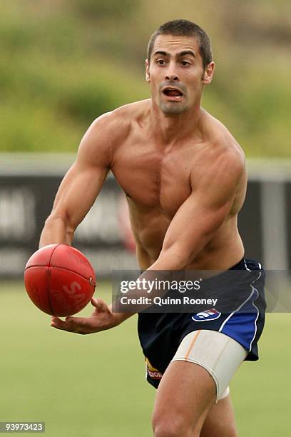 Daniel Giansiracusa of the Bulldogs handballs during a Western Bulldogs AFL training session at Whitten Oval on December 5, 2009 in Melbourne,...