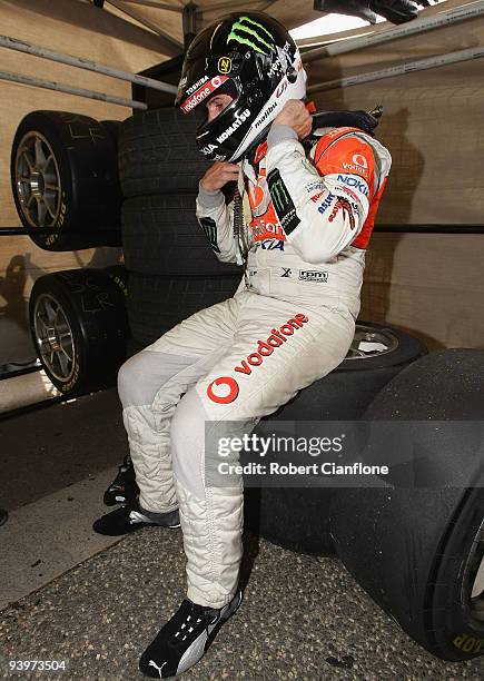 Jamie Whincup driver of the Team Vodafone Ford sits in the back of his pit garage after he won the championship during race 25 for the Sydney 500...