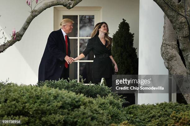 President Donald Trump shakes hands with Communications Director Hope Hicks on her last day of work at the White House before he departs March 29,...