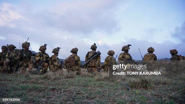 Soldiers take position during a simulated military excercise of the British Army Training Unit in Kenya together with the Kenya Defence Forces at the...
