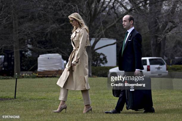 Ivanka Trump, assistant to U.S. President Donald Trump, left, and Stephen Miller, White House senior advisor for policy, walk on the South Lawn of...
