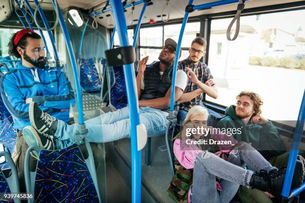 vandalism in the public bus - rude guy smoking pot and disturbing other passengers - cannabis shatter stock pictures, royalty-free photos & images