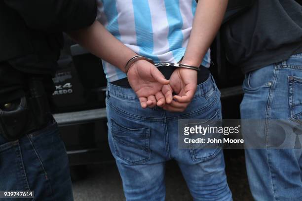 Homeland Security Investigations ICE agents detain a suspected MS-13 gang member and Honduran immigrant at his home on March 29, 2018 in Brentwood,...