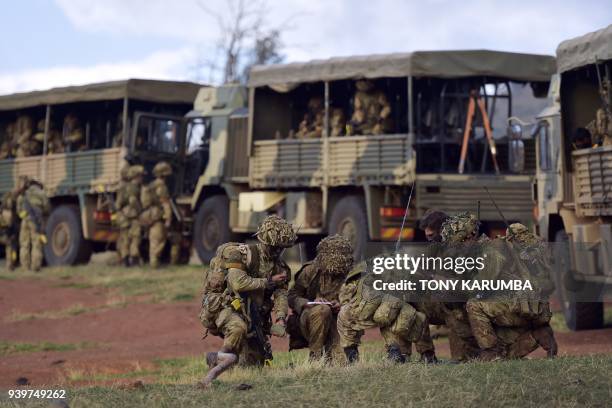Soldiers prepare for an overnight simulated military excercise of the British Army Training Unit in Kenya together with the Kenya Defence Forces at...