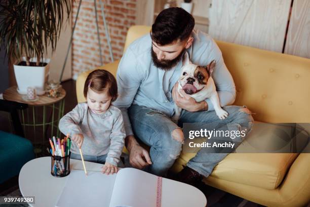 happy little family drawing in the living room - cute baby bulldogs stock pictures, royalty-free photos & images