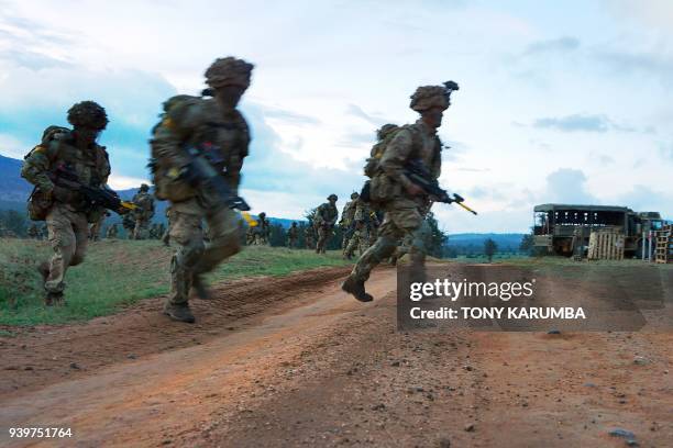 Soldiers run across a road during a simulated military excercise of the British Army Training Unit in Kenya together with the Kenya Defence Forces at...