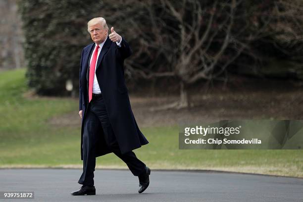 President Donald Trump walks across the South Lawn before departing the White House March 29, 2018 in Washington, DC. Trump is traveling to Ohio to...