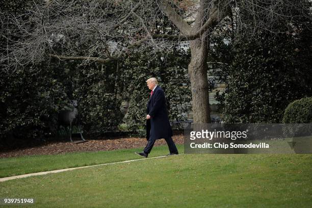 President Donald Trump walks across the South Lawn before departing the White House March 29, 2018 in Washington, DC. Trump is traveling to Ohio to...