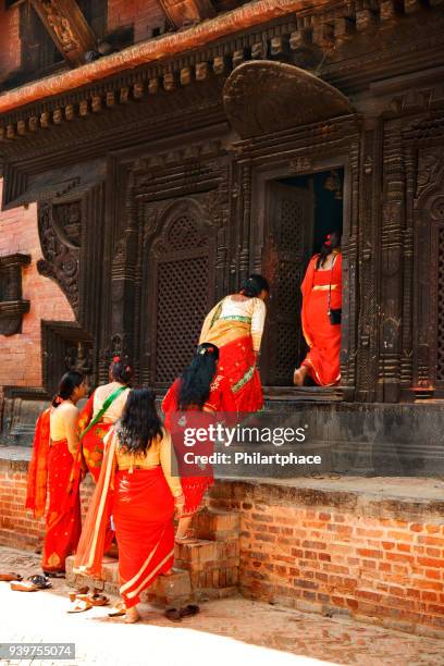 group of nepalese women in traditional clothing entering dattatraya temple - nepal festival stock pictures, royalty-free photos & images