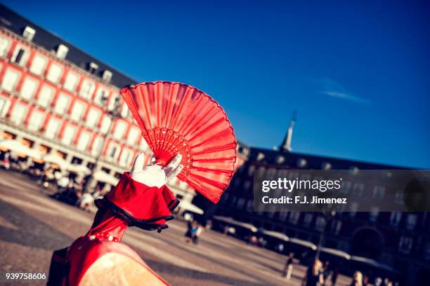typical spanish fan with the plaza mayor in the background - éventail photos et images de collection