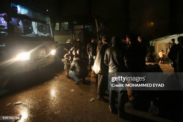 Evacuees from Eastern Ghouta arrive early on March 29 in Qalaat al-Madiq, some 45 kilometres northwest of the central city of Hama, following an...