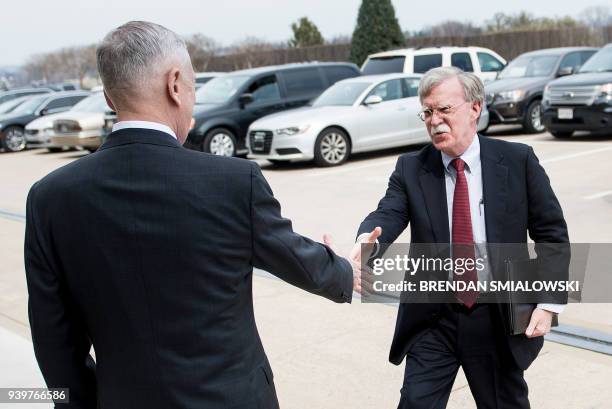 Secretary of Defense James Mattis greets incoming National Security Advisor John Bolton outside the Pentagon before a meeting March 29, 2018 in...