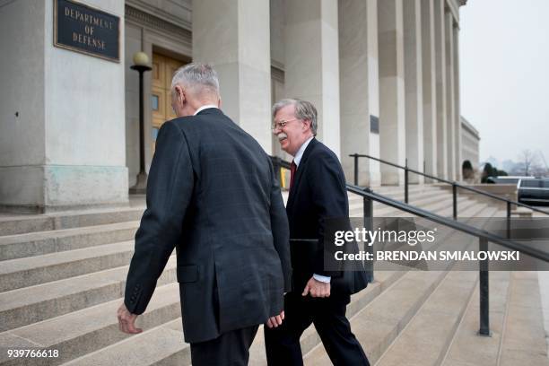 Secretary of Defense James Mattis and incoming National Security Advisor John Bolton walk into the Pentagon before a meeting March 29, 2018 in...