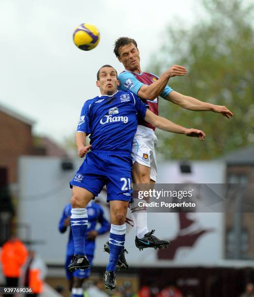 Scott Parker of West Ham United and Leon Osman of Everton battle for the ball during the Barclays Premier League match between West Ham United and...