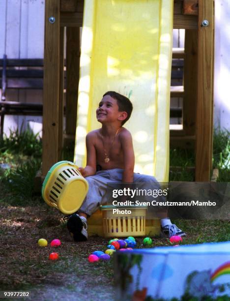 April 7, 2000: Elian Gonzalez plays with Easter-eggs in the garden of the house of his uncle Lazaro Gonzalez, on April 7 in Miami, USA. Elian...