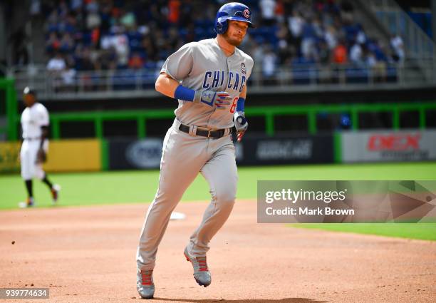 Ian Happ of the Chicago Cubs rounds the bases after hitting a lead off home run off the first pitch in first inning during Opening Day against the...