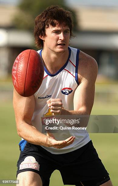 Tom Williams of the Bulldogs handballs during a Western Bulldogs AFL training session at Whitten Oval on December 5, 2009 in Melbourne, Australia.