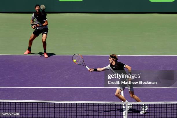 Andrey Rublev of Russia returns a shot to Steve Johnson and Sam Querrey while playing with Karen Khachanov of Russia in a semifinal match during the...