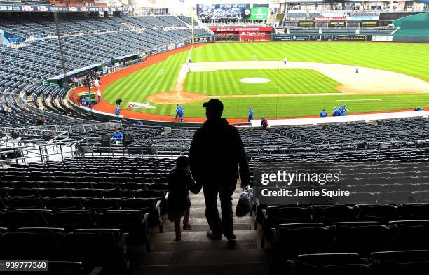 Father and his daughter walk through the stands toward the field as they arrive early on Opening Day ahead of the game between the Chicago White Sox...