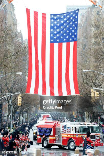 The flag draped coffin of FDNY Fire Marshal Capt. Christopher "Tripp" Zanetis brought by procession to his funeral in Washington Square Park March...